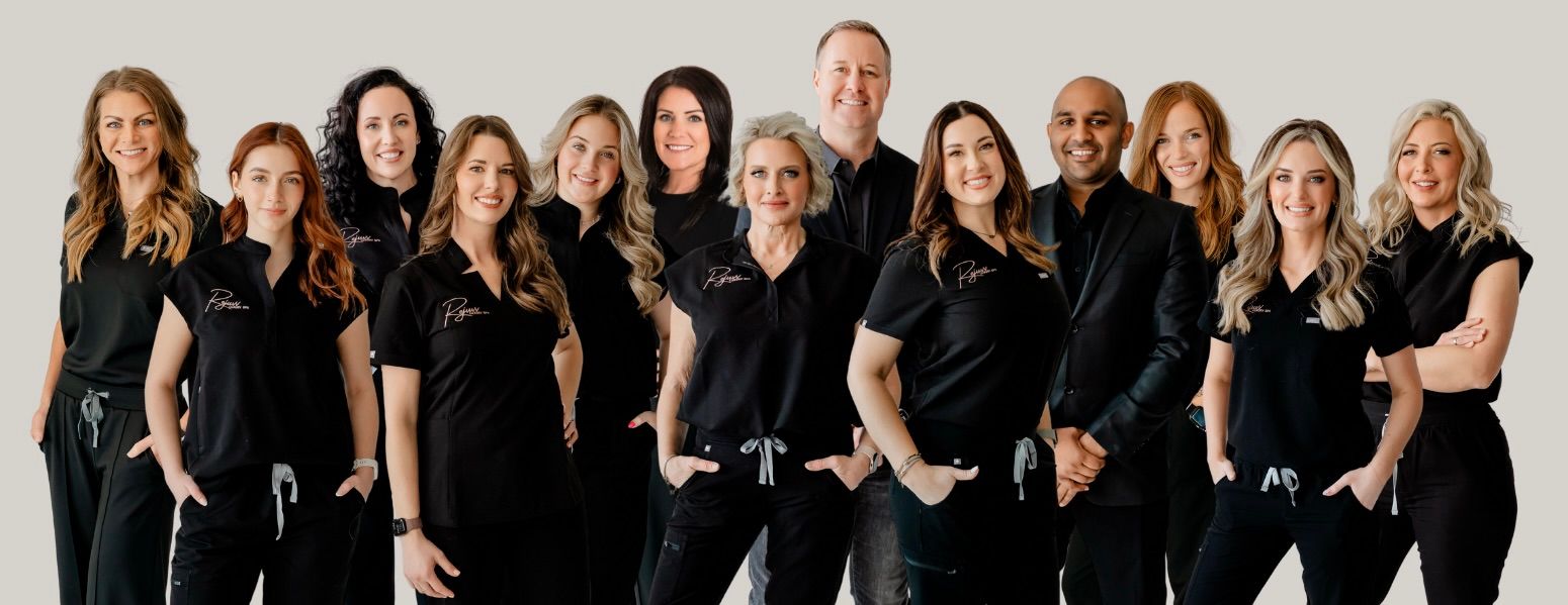 The Rejuvv Luxury Spa team standing together in black uniforms against a plain white backdrop.
