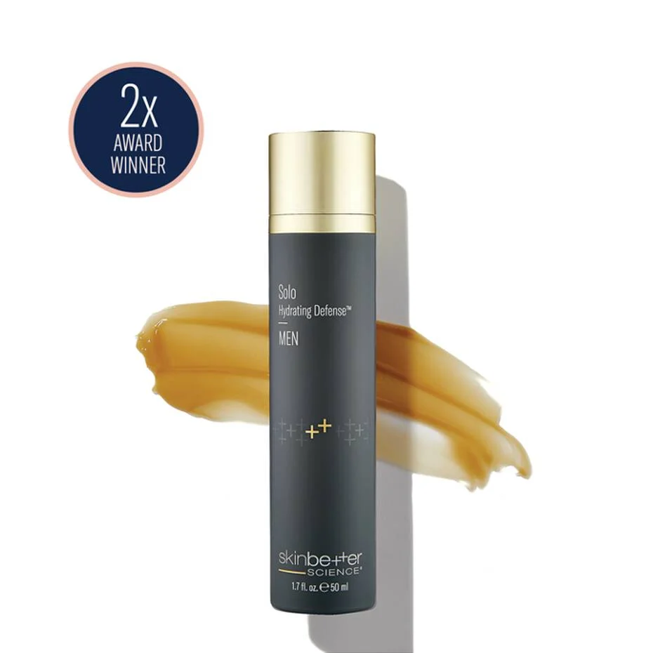 A dark grey skinbetter science Solo Hydrating Defense MEN bottle on a white background, beside an amber swatch and a “2x Award Winner” roundel.